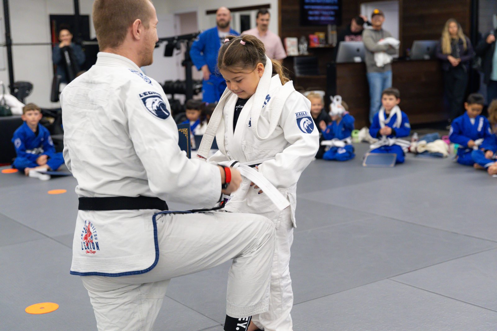 Coach teaching a young student technique